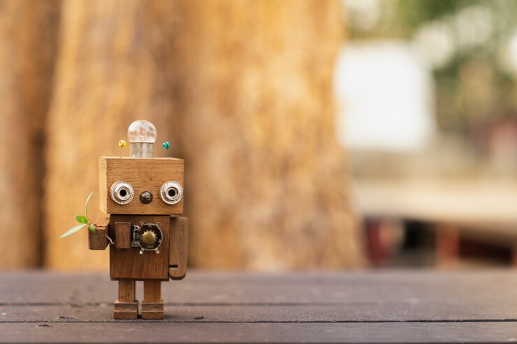 Foto brazo robot de madera con hojas verdes, concepto de tecnología ecología.