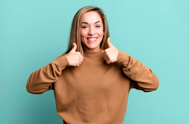 breit lächelnd glücklich positiv positiv und erfolgreich mit beiden Daumen hoch