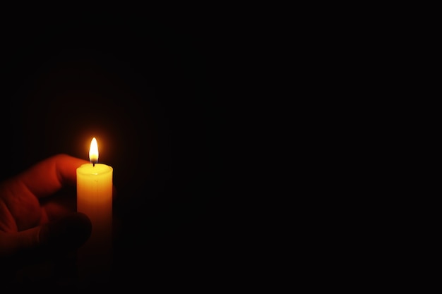 Brennende Kerze Docht aus einer Kerze in einer Feuerflamme. Symbol der Traurigkeit und Einsamkeit. Eine Zeit des Beileids. Brennende Wachskerze. Religion.
