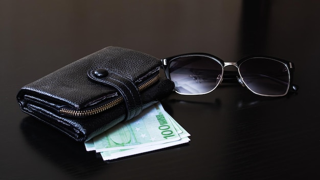 Brieftasche Sonnenbrille Euro auf einem hölzernen Hintergrund