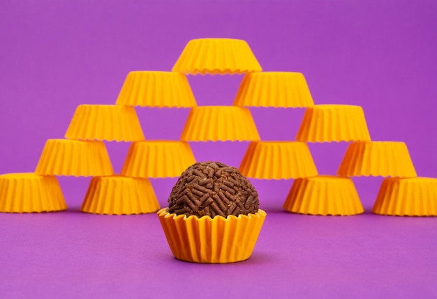 Brigadeiros, traditionelle brasilianische Süßigkeit, auf violettem Hintergrund, gelbe Verpackung