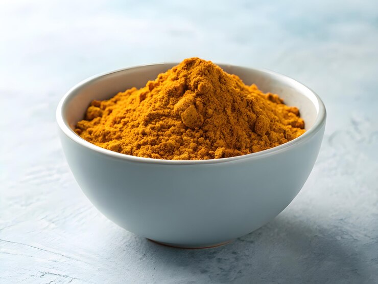 Bright Turmeric Powder in a Teal Bowl