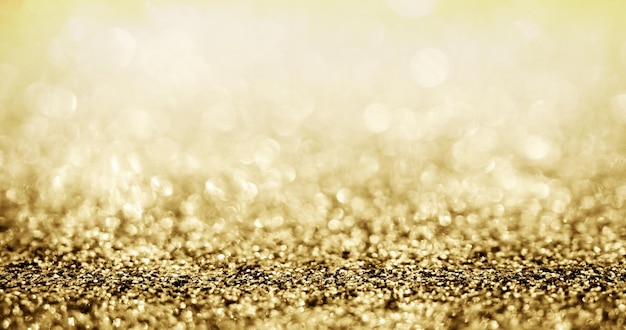 Brilho de glitter dourado abstrato com fundo bokeh