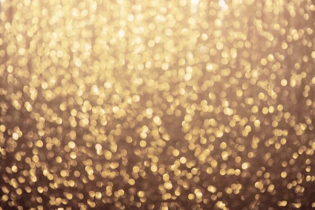 Brilhos de brilho desfocado dourado, fundo festivo