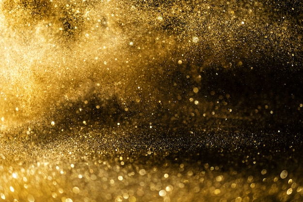 El brillo enciende el fondo del grunge, el brillo del oro defocused fondo abstracto de las luces del centelleo.