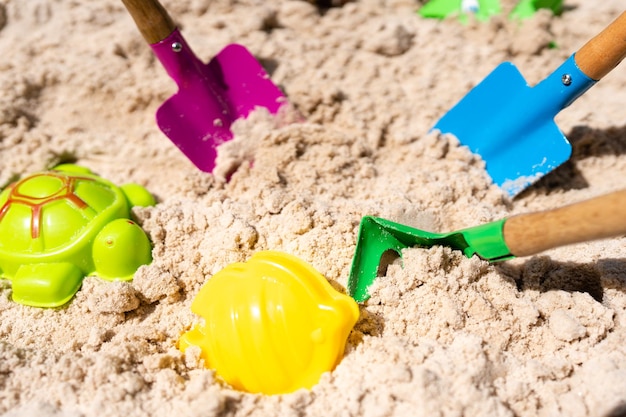 Brinquedo de praia no fundo da praia de areia ao meio-dia.