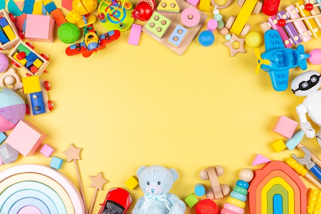 brinquedos educativos coloridos de plástico de madeira e fofinhos para crianças com fundo amarelo pastel.