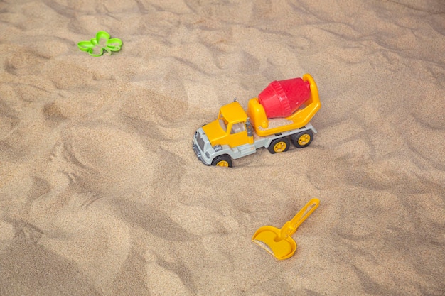 Brinquedos infantis de plástico brilhante na areia