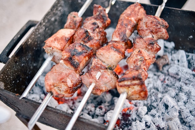 Brocheta a la plancha. Las brochetas de cerdo se cuecen sobre carbón. Picnic de comida callejera. kebab, barbacoa