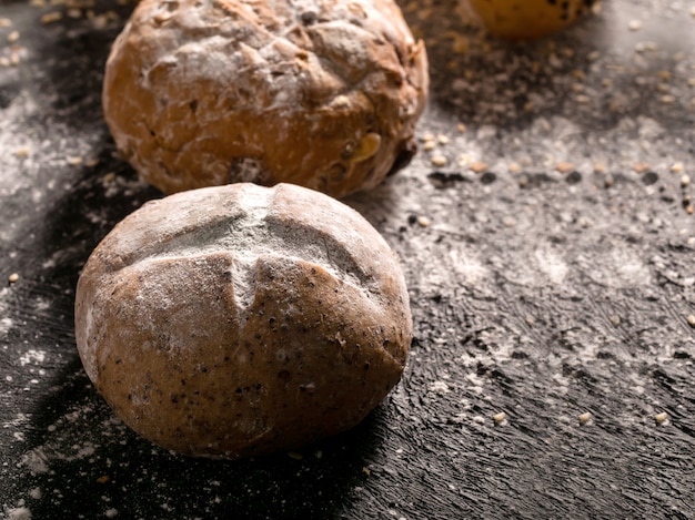 Brötchen auf schwarzem Holzhintergrund platziert