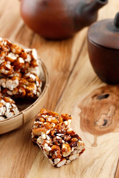 Brondong Jagung oder Bororndong, javanesischer traditioneller Snack, süßes Popcorn mit klebrigem Palmzucker. Serviert mit Tee