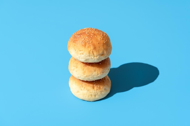 Brotbrötchen in hellem Licht isoliert auf blauem Hintergrund