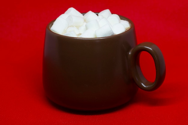 Brown Cup heißer Kakao mit Marshmallows auf rotem Grund. Guten Morgen.