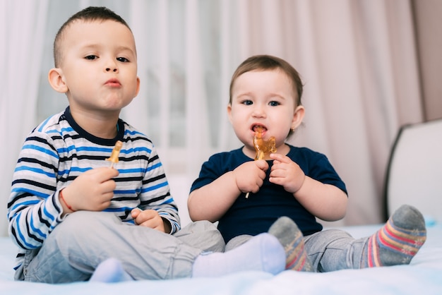 Bruder und Schwester essen Lutscher in Form eines Schwanzes sehr süß