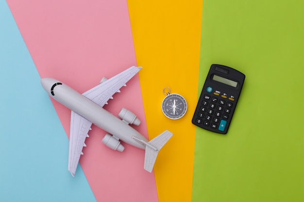 Brújula, calculadora y avión. Costo de viaje