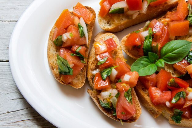 Bruscheta, antepastos Italiano típico com tomate, manjericão e torrada