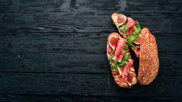 Bruschetta com presunto, figos frescos e queijo No fundo antigo Comida saudável Espaço livre para texto Vista superior