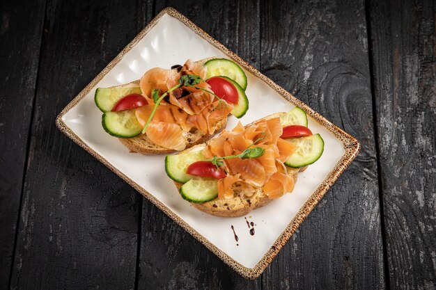 Bruschetta con mariscos y verduras en un plato blanco.