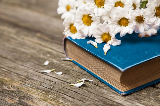 Buch und Blumen auf Holz