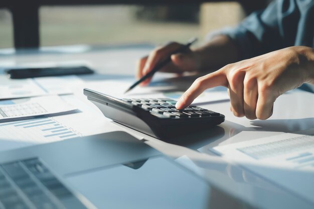 Buchhalter verwendet Taschenrechner zur Berechnung des Finanzberichts im Büro