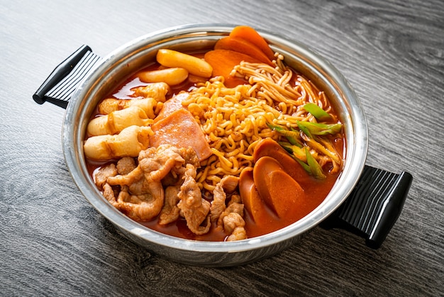 Budae Jjigae o Budaejjigae (estofado del ejército o estofado de base del ejército). Está cargado de kimchi, spam, salchichas, fideos ramen y mucho más: el popular estilo de comida coreana de olla caliente.
