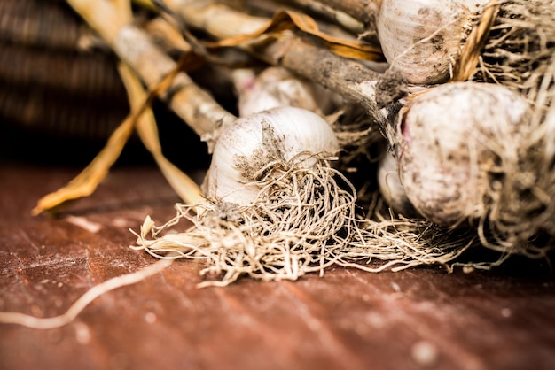 Bulbos de cebolla recién excavados en la madera. Agricultura de huerta. Cebolla almacenada en cesta