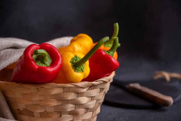 Foto bunte lange paprika auf dunklem hintergrund