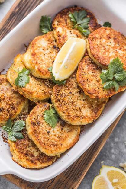 Buñuelos de verduras de coliflor vegana en la mesa de la cocina. Tortitas o chuletas vegetarianas fritas. El concepto de comida rápida.