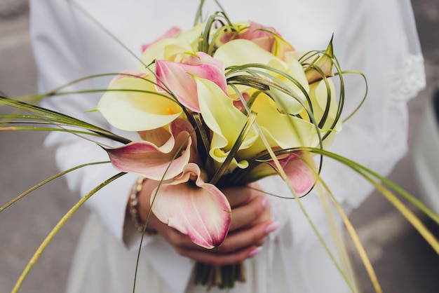 Buquê de casamento de lírios brancos elegante closeup nas mãos