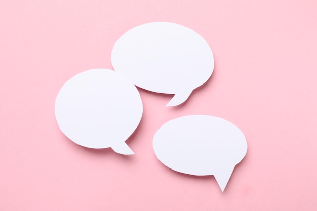 Burbujas de habla en blanco sobre un fondo rosa claro Espacio para el texto