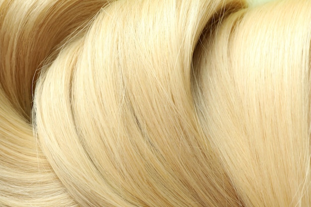 Cabelo feminino loiro em todo o fundo, close-up