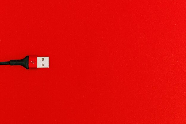 Cabo usb preto na tecnologia de assunto de fundo vermelho