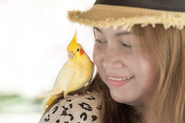 Cacatua no ombro da mulher.