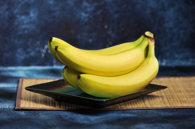 Cacho de bananas maduras em um prato