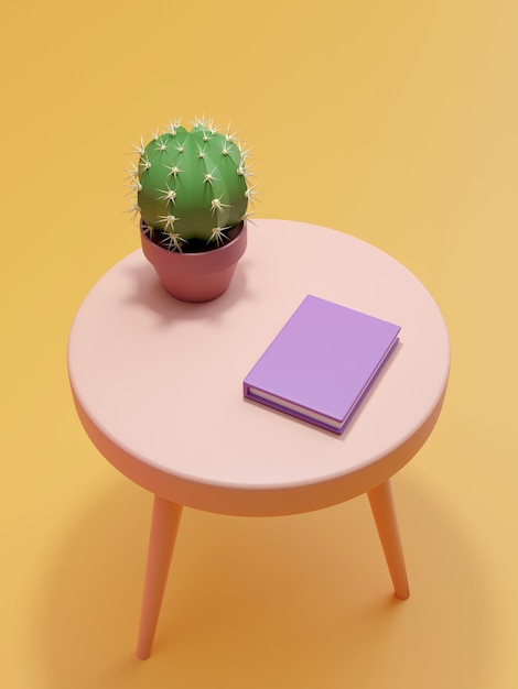 Un cactus y un libro sobre la mesa.