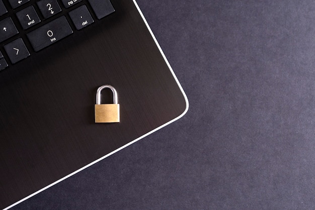 Cadeado dourado no teclado do laptop, proteção de segurança da informação, senha.