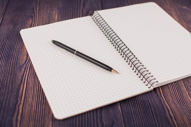 Caderno com caneta em uma mesa de madeira