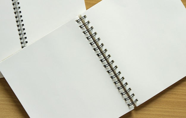 Caderno espiral em branco sobre fundo de madeira