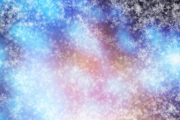 Foto caen los copos de nieve brillantes en el fondo abstracto