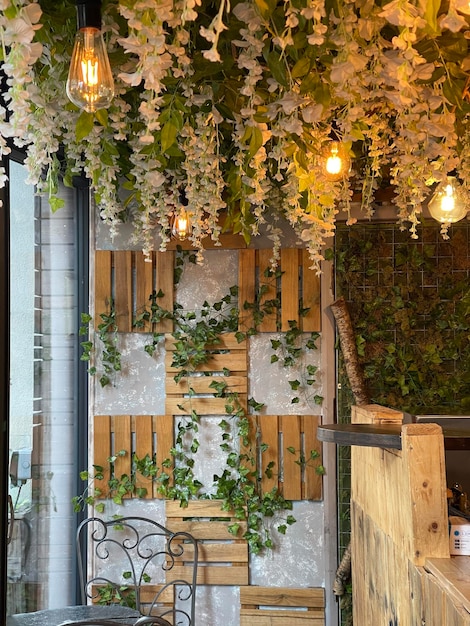 Café aconchegante decorado com plantas perenes e lâmpadas vintage