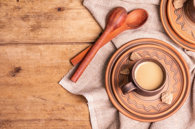 Café aromático em um estilo caseiro aconchegante. Canecas de cerâmica, bebida quente, mesa de madeira. Bom dia bom humor vista de cima