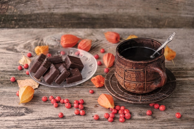 Café caliente en una gran taza de cerámica vintage y bombones