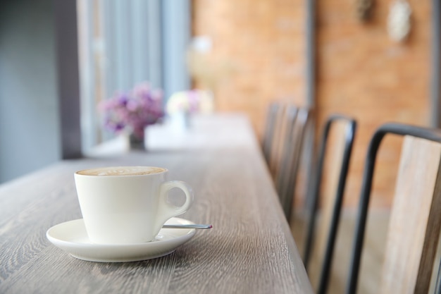 Café com leite quente em fundo de madeira