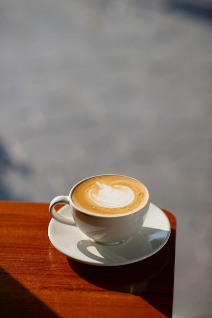 Café com leite quente na mesa de madeira relaxa o tempo