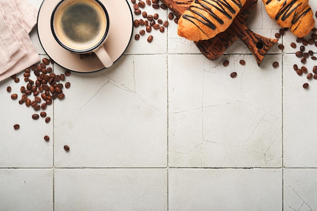 Café y croissant Café espresso y croissant con chocolate en una vieja mesa de azulejos agrietados Croissant perfecto Desayuno por la mañana Estilo rústico Vista superior Maqueta