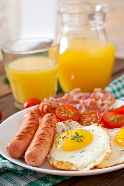 Café da manhã inglês - torradas, ovo, bacon e legumes em estilo rústico na mesa de madeira