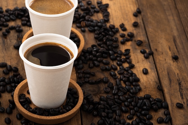 Café em copo de papel na madeira