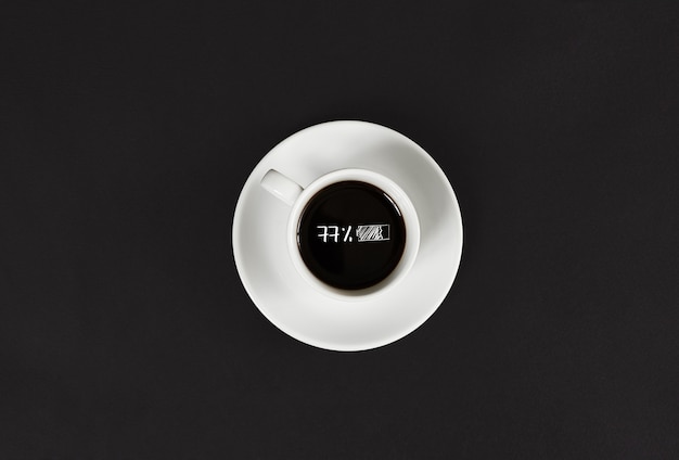 Café em xícara branca com uma inscrição em fundo de ardósia preta