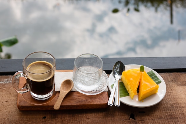 Café fresco en un vaso y tarta de naranja.