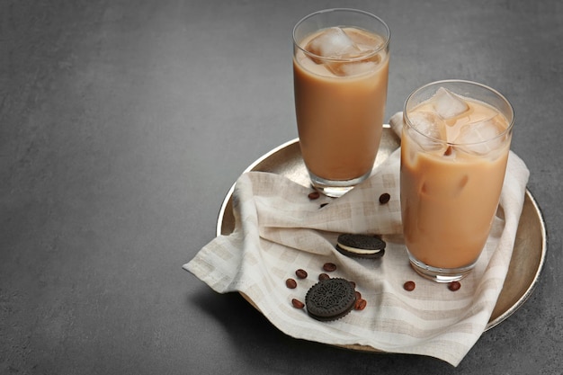 Café gelado e biscoitos num prato de prata.